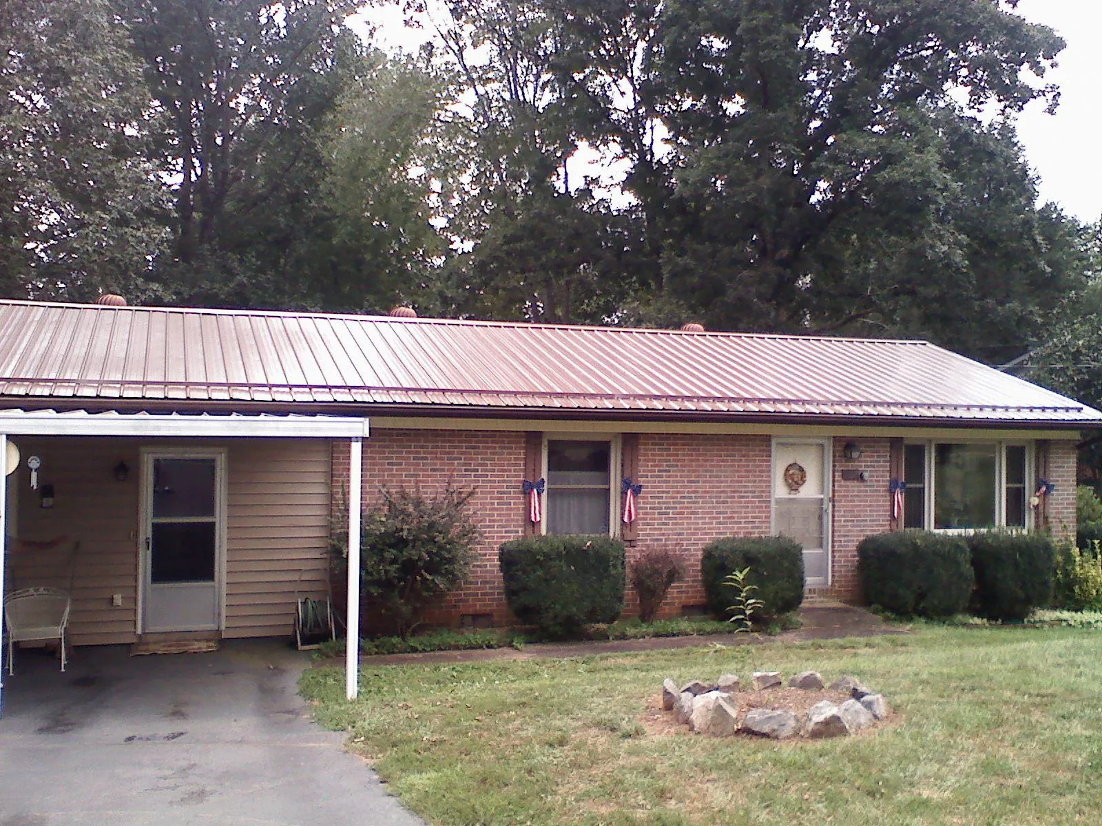 Bronze metal roof and carport on a brick ranch home — Roof Repair work by our crew in Menlo