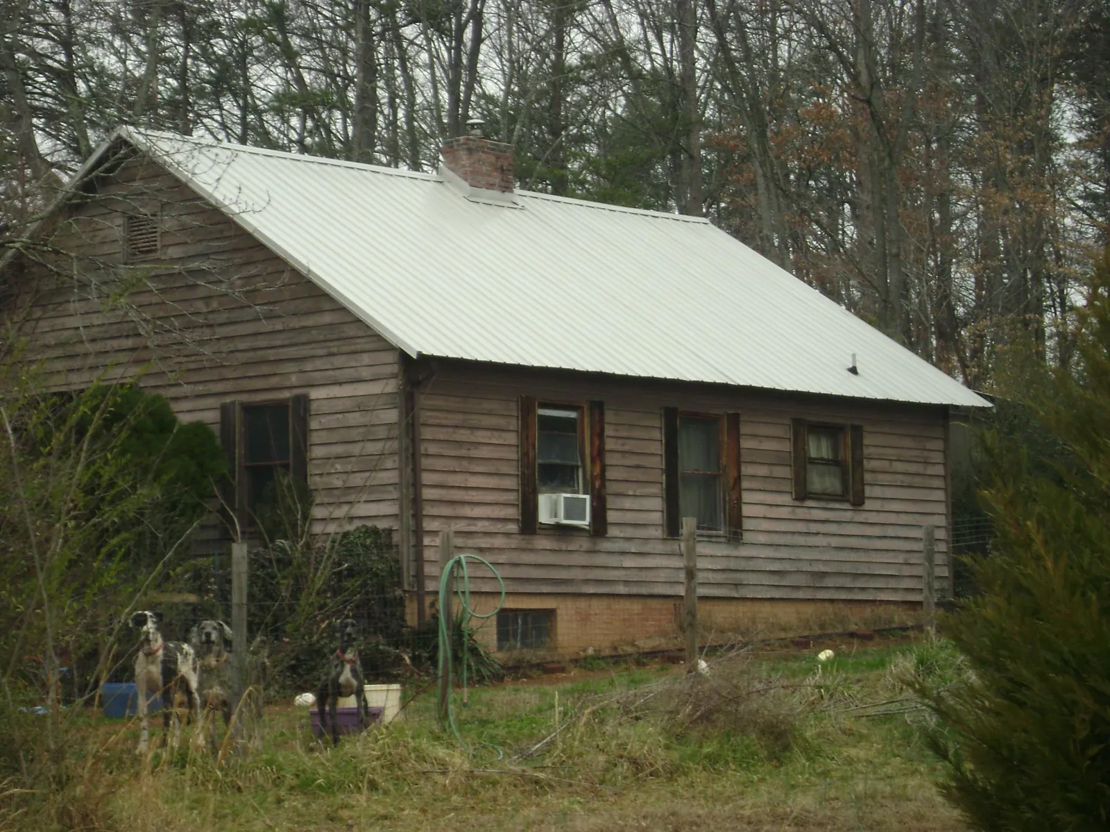 White metal roof on an old wood sided farmhouse, from a Metal Roof Installation job in Menlo